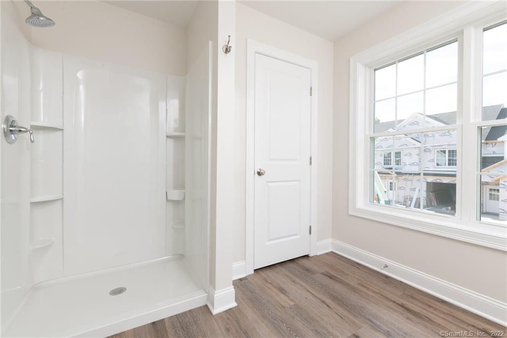 29 Covey Road, Unit 13 Burlington, CT 06013 - Photo 33 of 34 a view of an empty room with wooden floor and a window