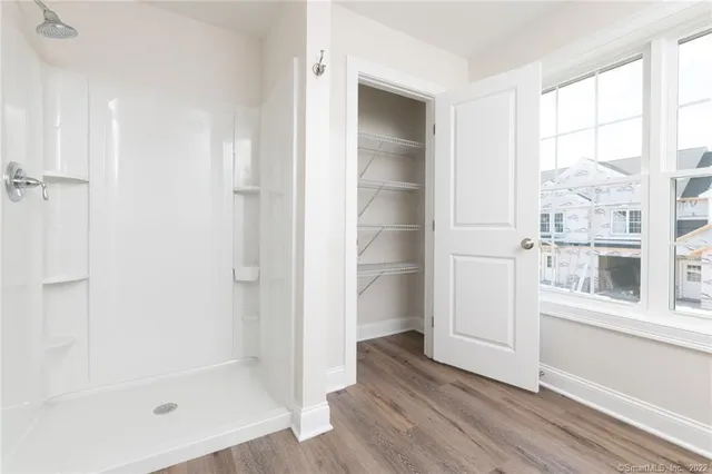 a view of a bathroom with a tub and window