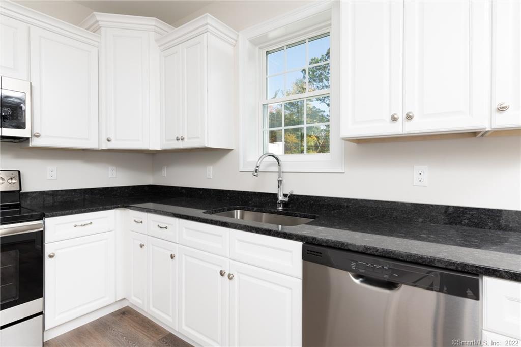 29 Covey Road, Unit 13 Burlington, CT 06013 - Photo 9 of 34 a kitchen with granite countertop white cabinets and a sink