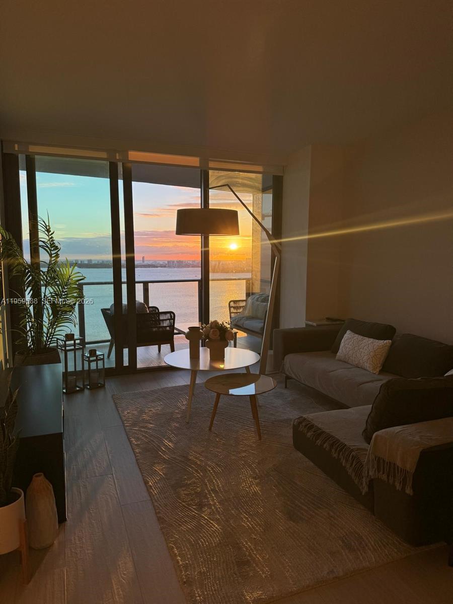 460 Northeast 28th Street, Unit 3307 Miami, FL 33137 - Photo 2 of 13 a living room with furniture and a large window