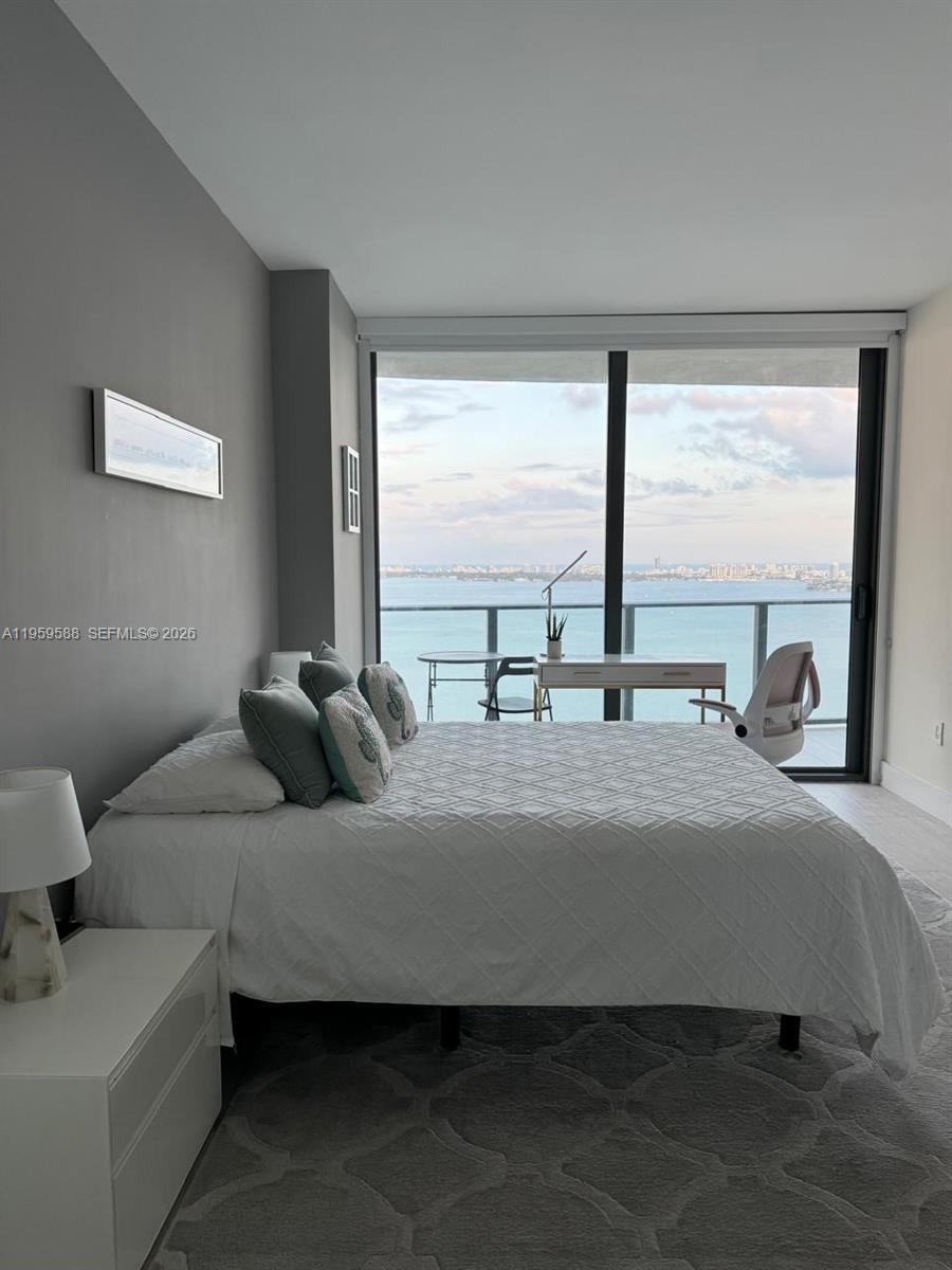 460 Northeast 28th Street, Unit 3307 Miami, FL 33137 - Photo 7 of 13 a bedroom with a bed and a large window