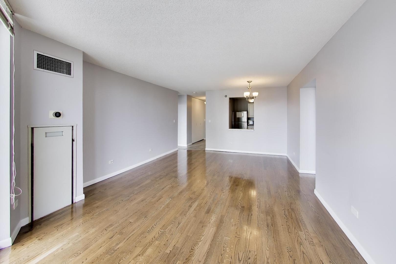 111 West Maple Street, Unit 1503 Chicago, IL 60610 - Photo 14 of 39 a view of empty room with wooden floor