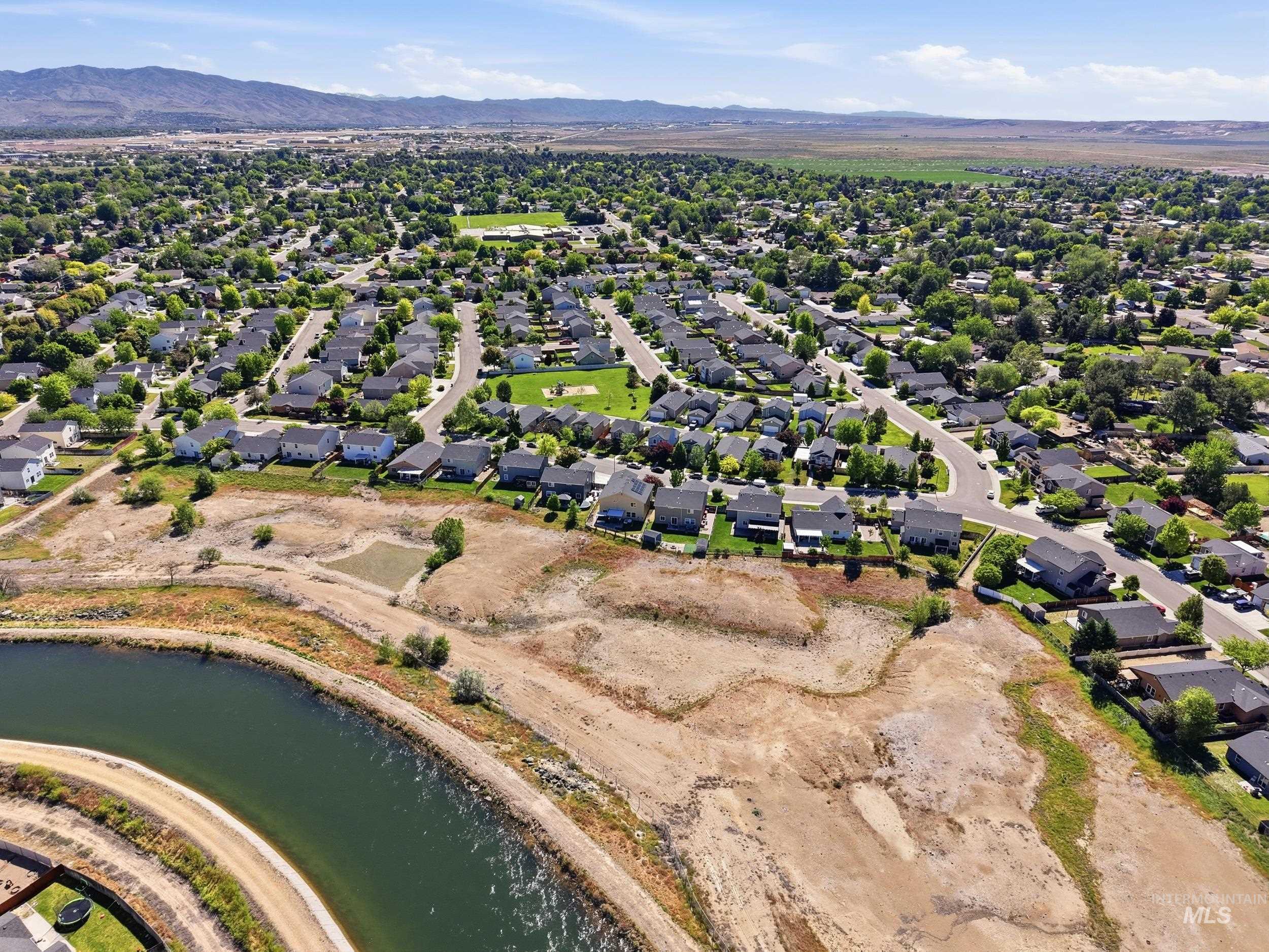 4855 South Chex Way Boise, ID 83709 - Photo 47 of 47 Aerial perspective of a developed residential neighborhood featuring numerous single-family homes with gray roofs and varied light-colored exteriors