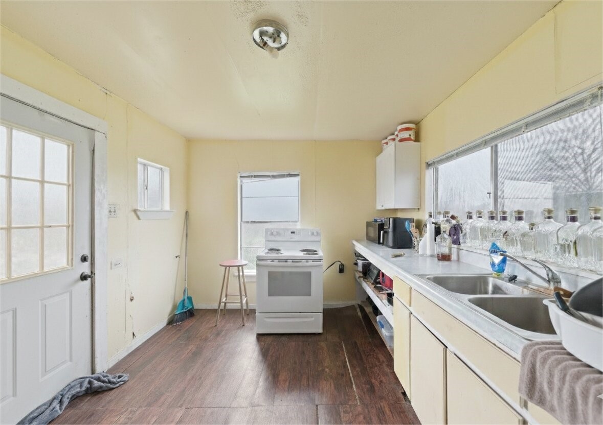 17714 Day Road Needville, TX 77461 - Photo 14 of 22 a kitchen with a sink stove and cabinets