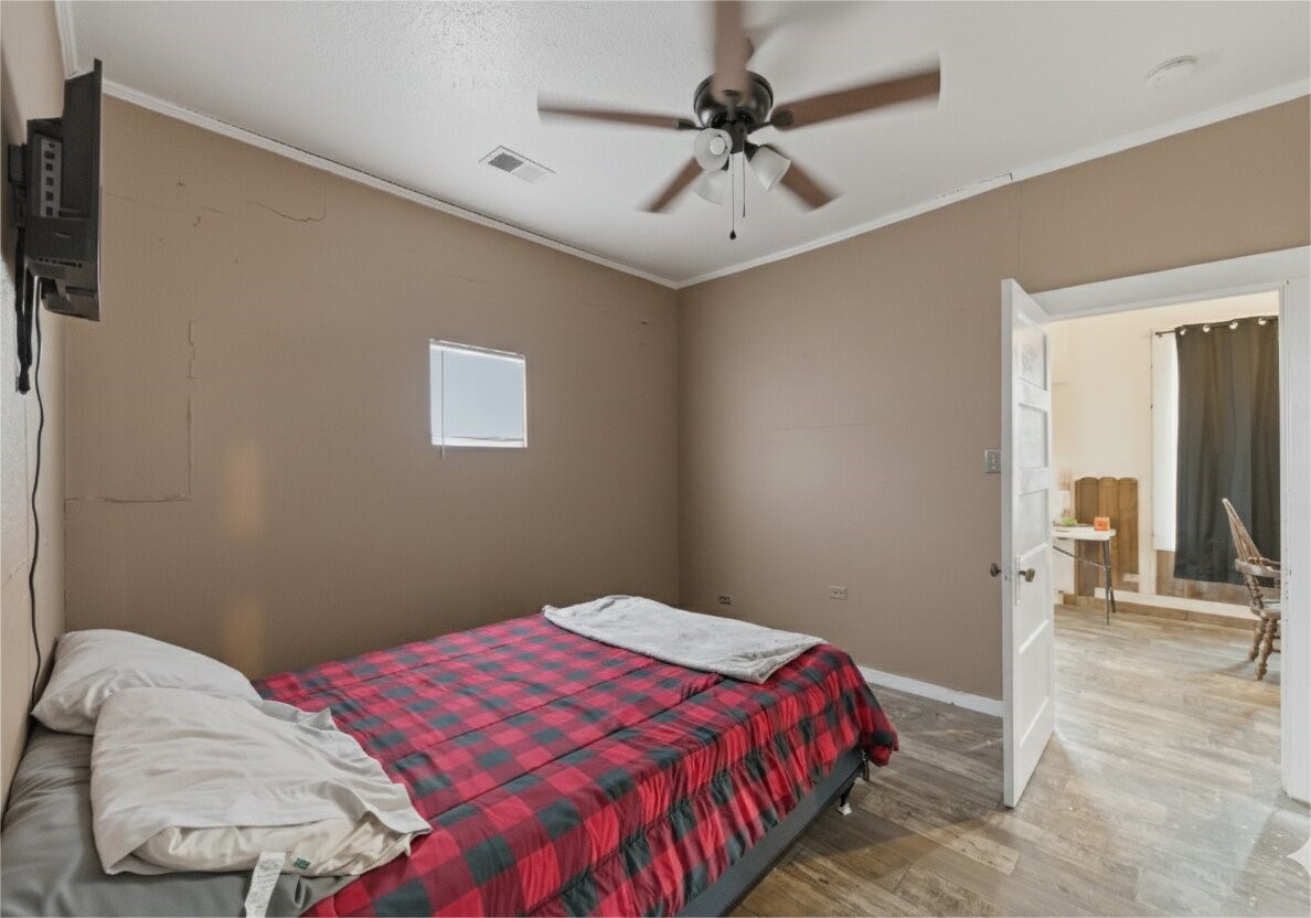 17714 Day Road Needville, TX 77461 - Photo 18 of 22 a bedroom with a bed and a chandelier