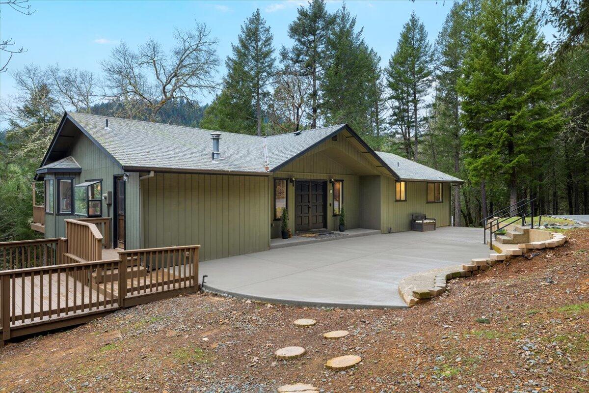 350 Splendor Drive Wilderville, OR 97543 - Photo 4 of 57 a front view of a house with a yard and garage