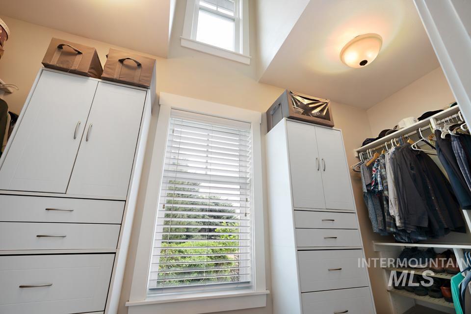 8271 Washoe Road Fruitland, ID 83619 - Photo 23 of 29 Integrated custom closet system featuring white cabinetry with brushed nickel hardware, pull-out drawers, and shelving