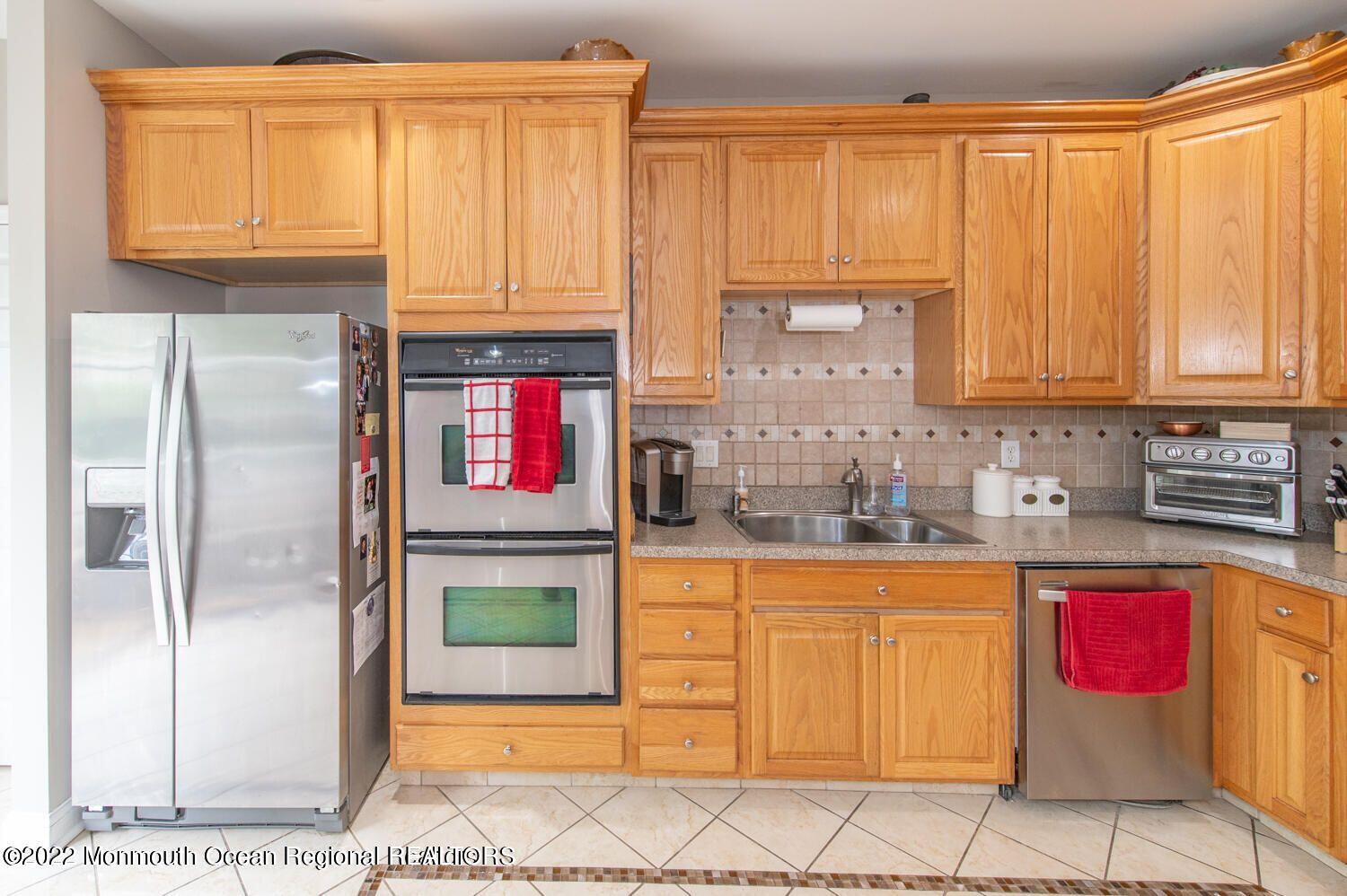 109 Brookfield Drive Jackson, NJ 08527 - Photo 17 of 40 a kitchen with stainless steel appliances granite countertop a refrigerator and cabinets