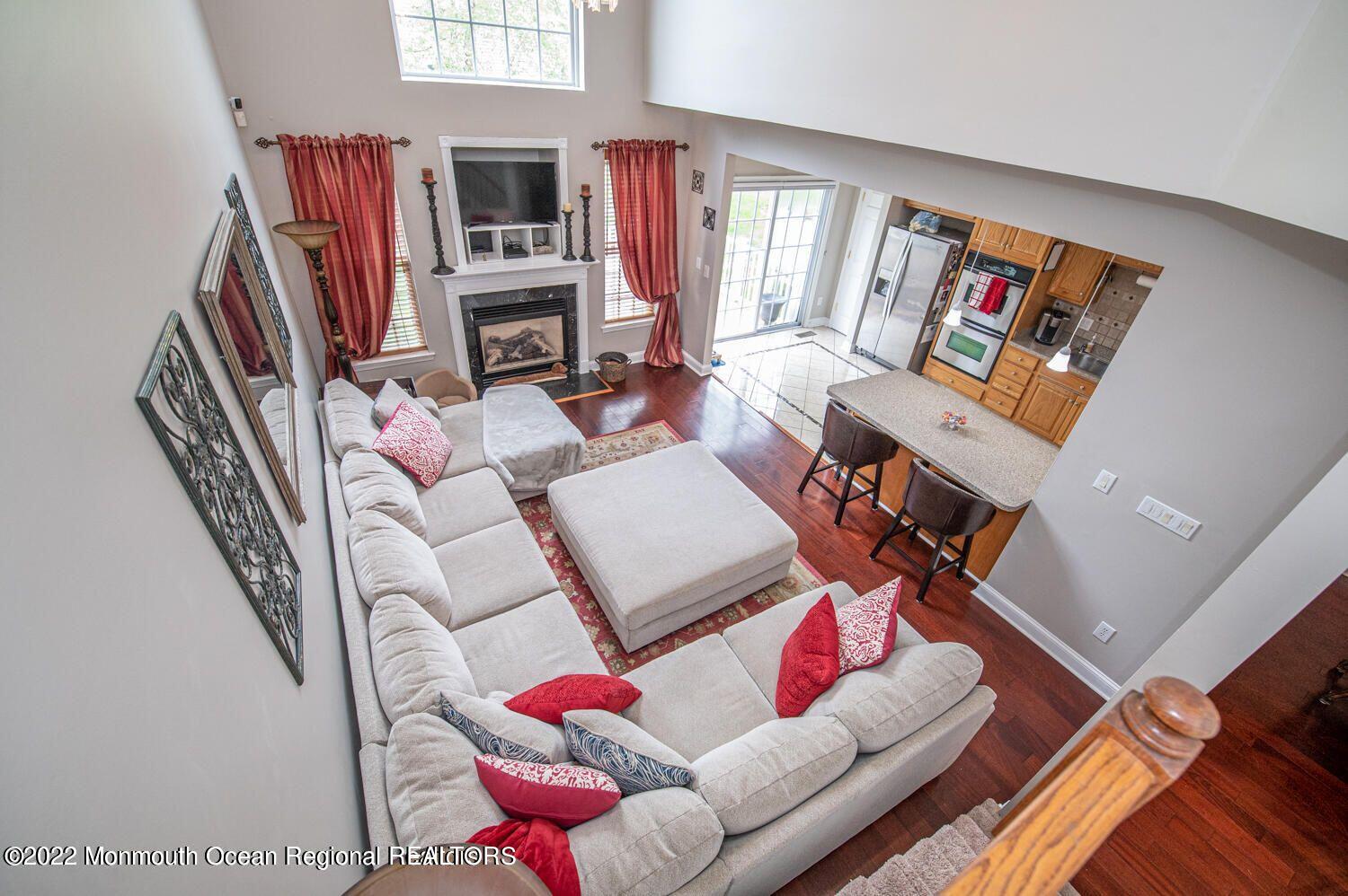 109 Brookfield Drive Jackson, NJ 08527 - Photo 23 of 40 a living room with furniture a flat screen tv and a fireplace