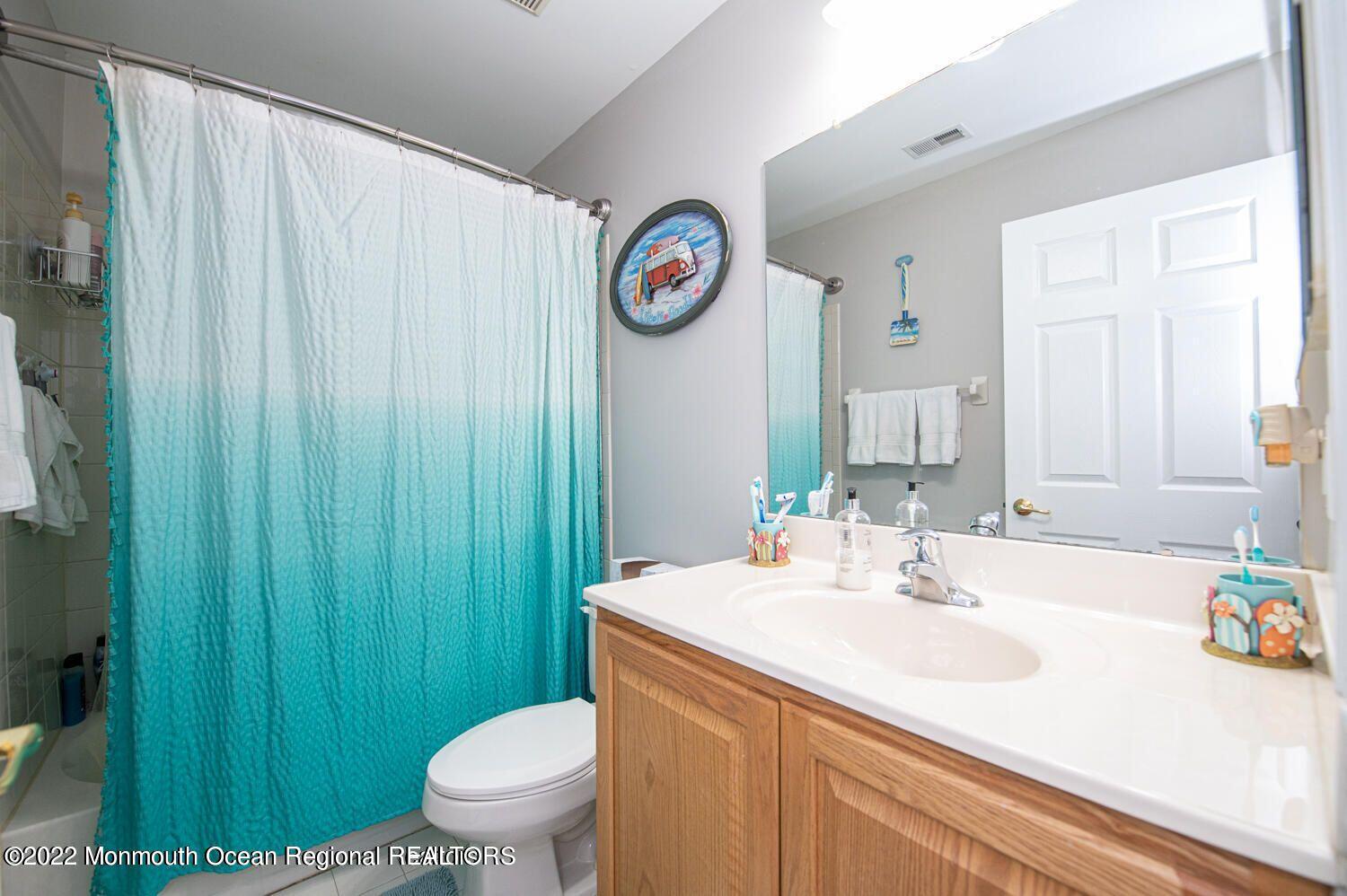 109 Brookfield Drive Jackson, NJ 08527 - Photo 31 of 40 a bathroom with a sink a toilet and a large mirror