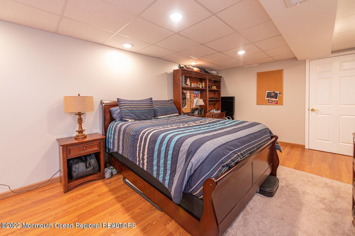 109 Brookfield Drive Jackson, NJ 08527 - Photo 33 of 40 a bedroom with a bed and a night stand