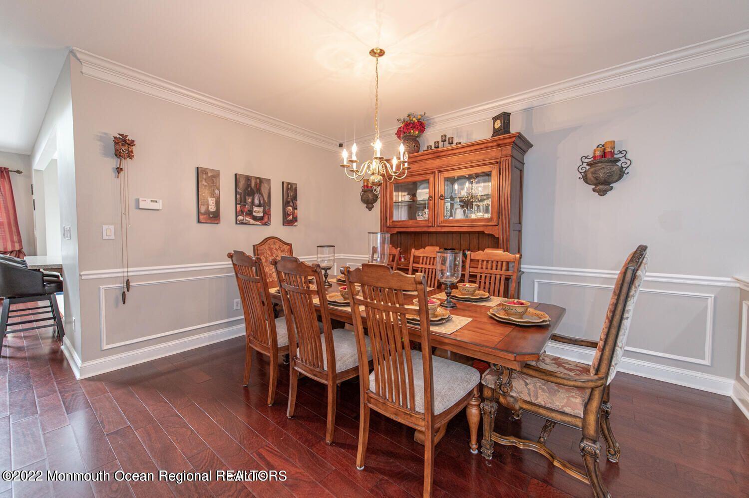109 Brookfield Drive Jackson, NJ 08527 - Photo 9 of 40 a view of a dining room with furniture a chandelier and wooden floor