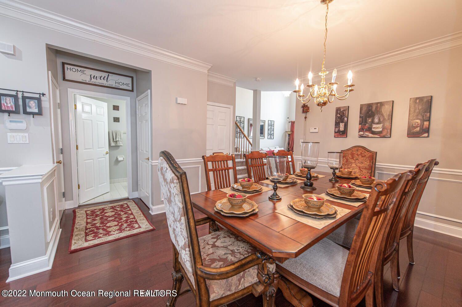 109 Brookfield Drive Jackson, NJ 08527 - Photo 10 of 40 a dining room with furniture a chandelier and wooden floor