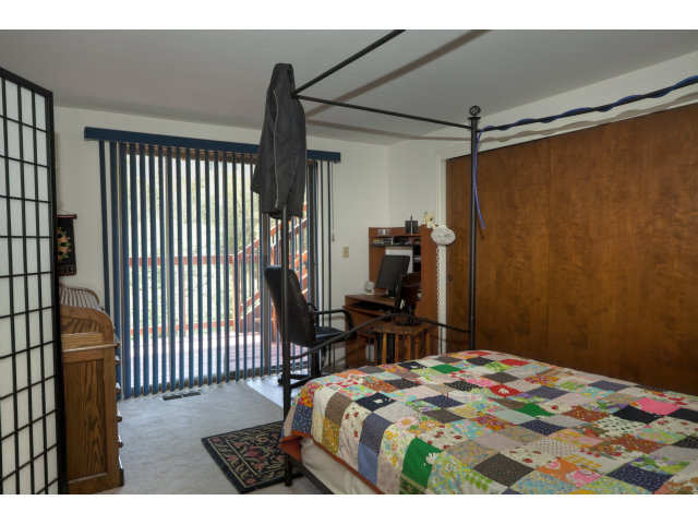 175 Ridgeway Road Hillsborough, CA 94010 - Photo 15 of 23 a bedroom with a bed and a flat tv screen on the dresser