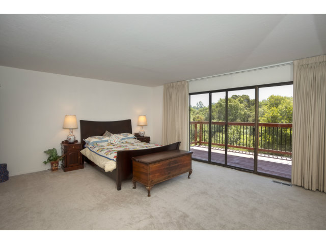 175 Ridgeway Road Hillsborough, CA 94010 - Photo 10 of 23 a spacious bedroom with a bed and large window