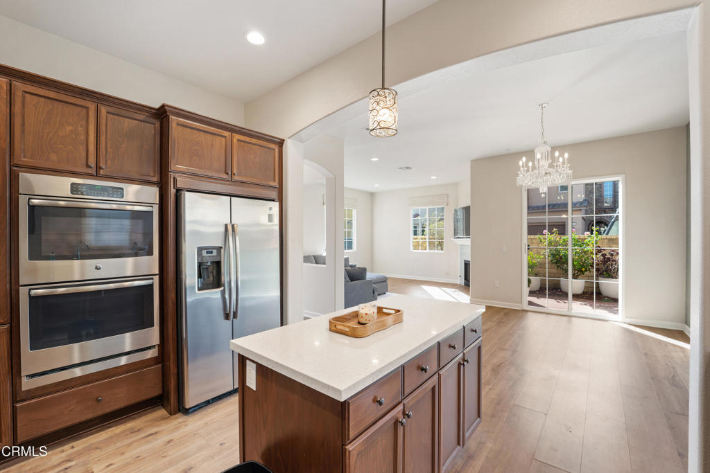 1655 Range Road Oxnard, CA 93036 - Photo 15 of 34 a kitchen that has a kitchen island wooden cabinets and stainless steel appliances