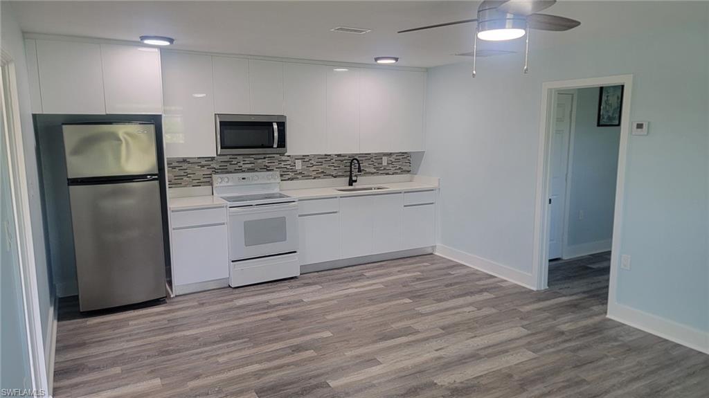 27020 Williams Road, Unit 5 Bonita Springs, FL 34135 - Photo 1 of 6 a kitchen with stainless steel appliances a refrigerator stove and microwave