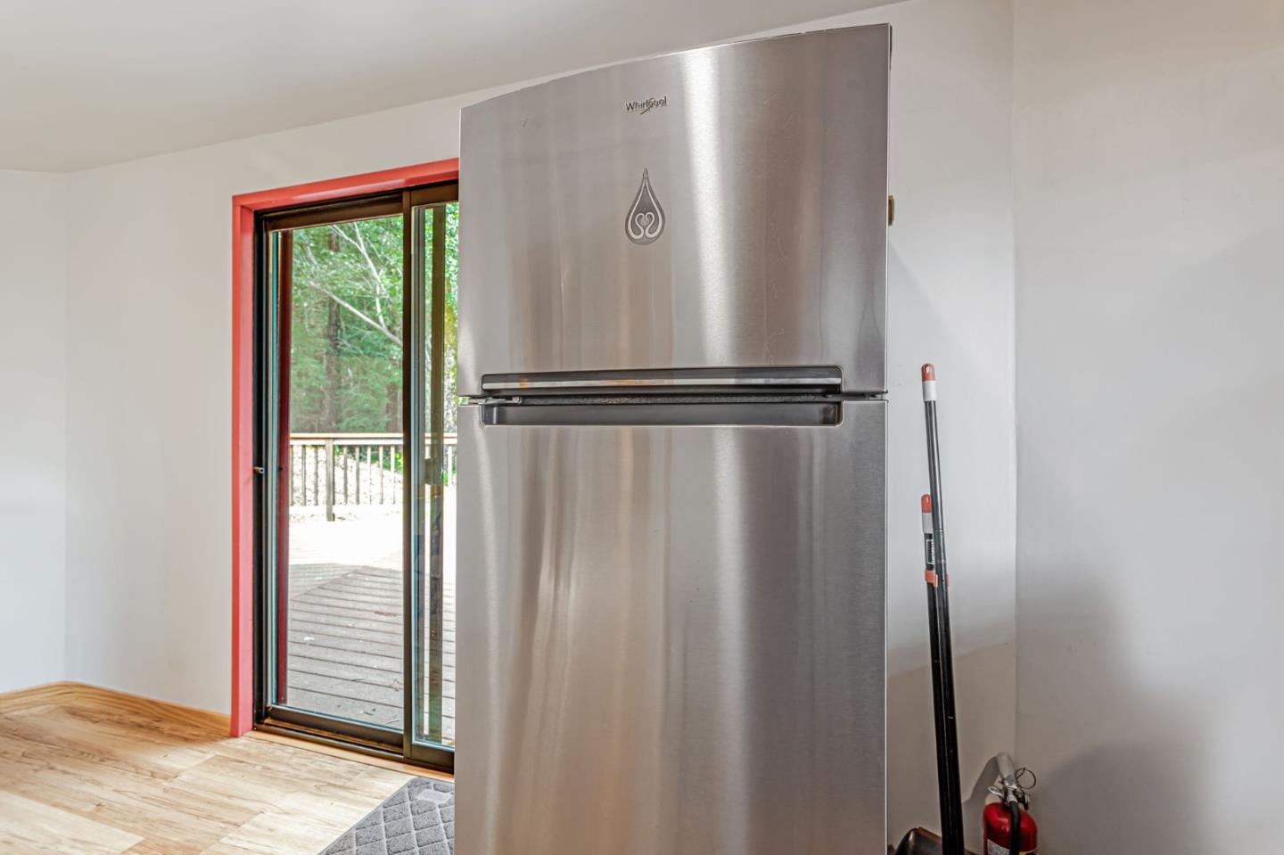 12845 Love Creek Road Ben Lomond, CA 95005 - Photo 25 of 61 a white refrigerator freezer and a wooden floor