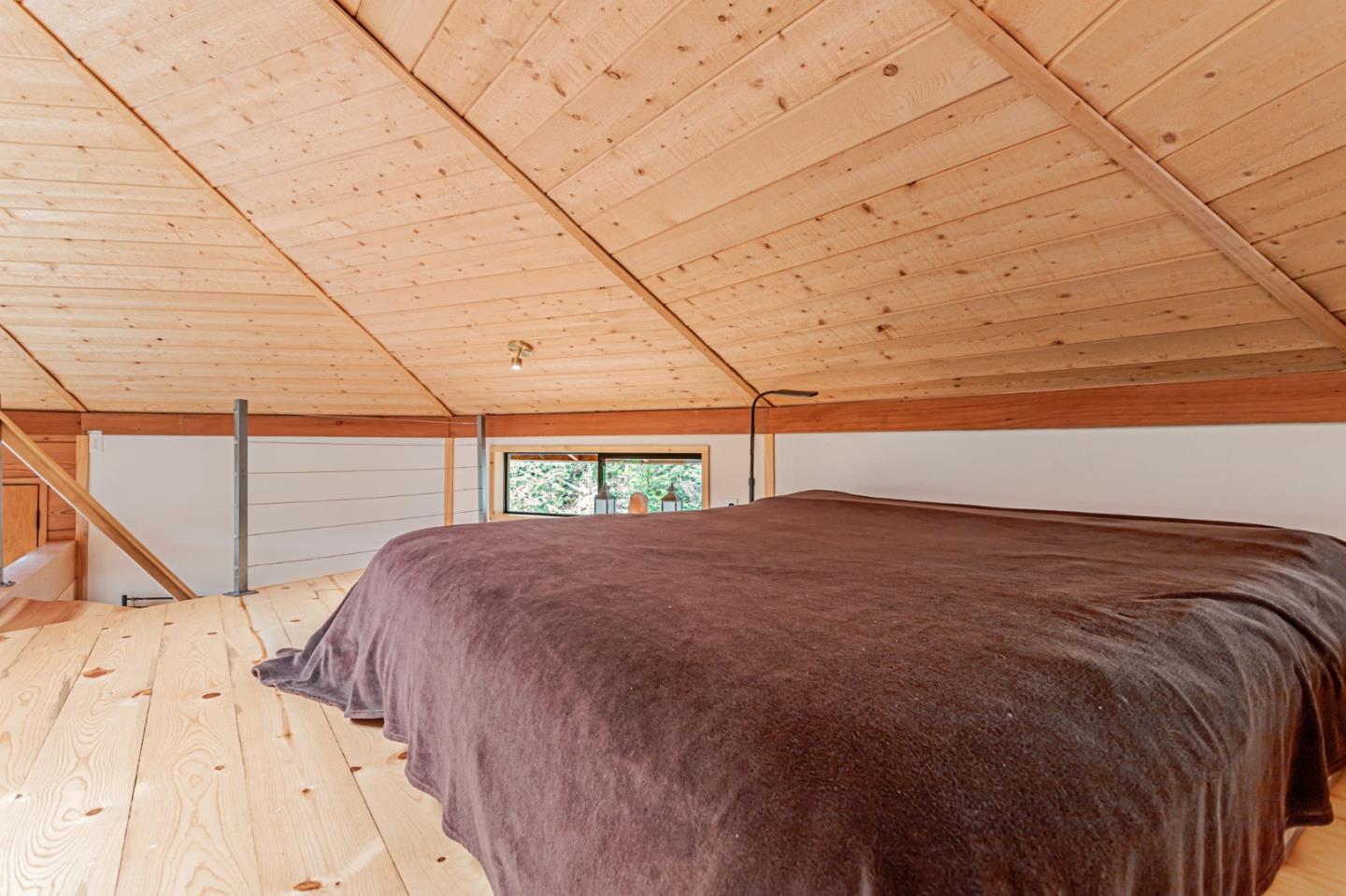 12845 Love Creek Road Ben Lomond, CA 95005 - Photo 28 of 61 a bed sitting in a bedroom next to a window