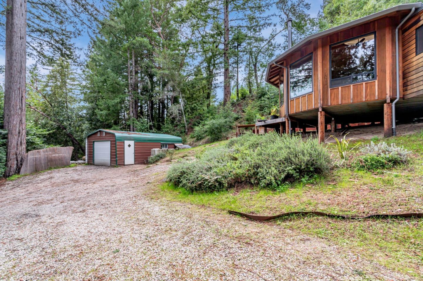 12845 Love Creek Road Ben Lomond, CA 95005 - Photo 5 of 61 a front view of a house with garden and plants