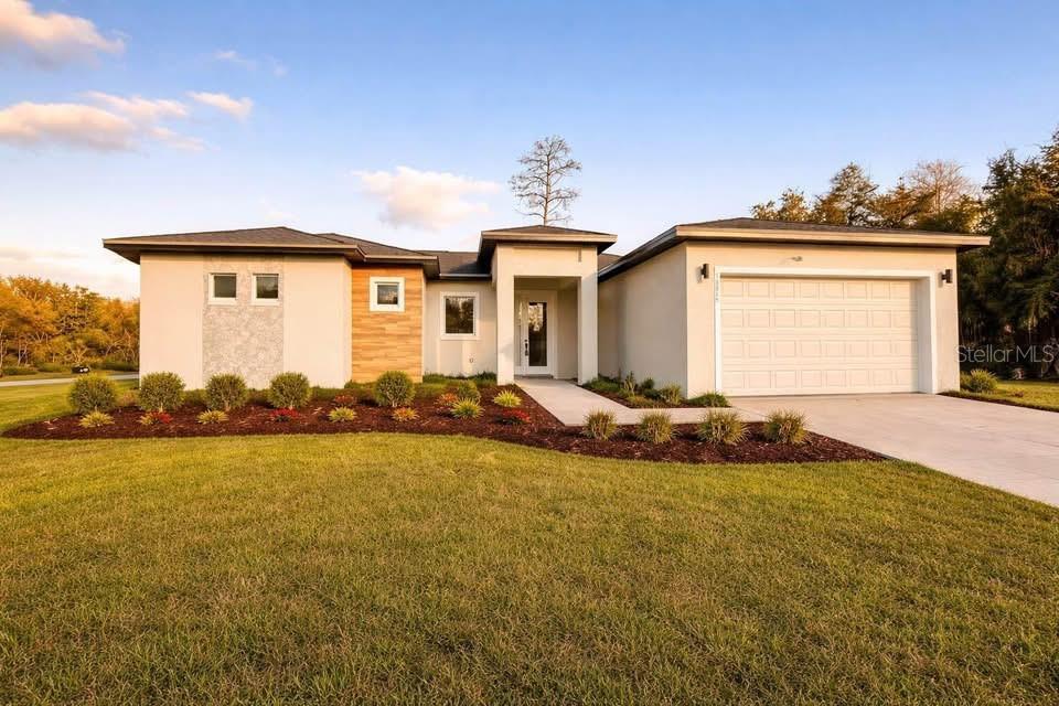 15215 Southwest 43rd Court Ocala, FL 34473 - Photo 1 of 29 a front view of a house with a yard