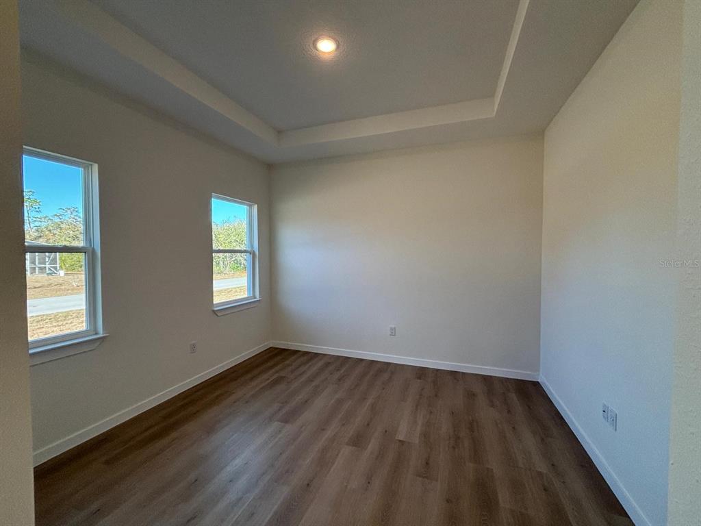 15215 Southwest 43rd Court Ocala, FL 34473 - Photo 14 of 29 an empty room with wooden floor and windows