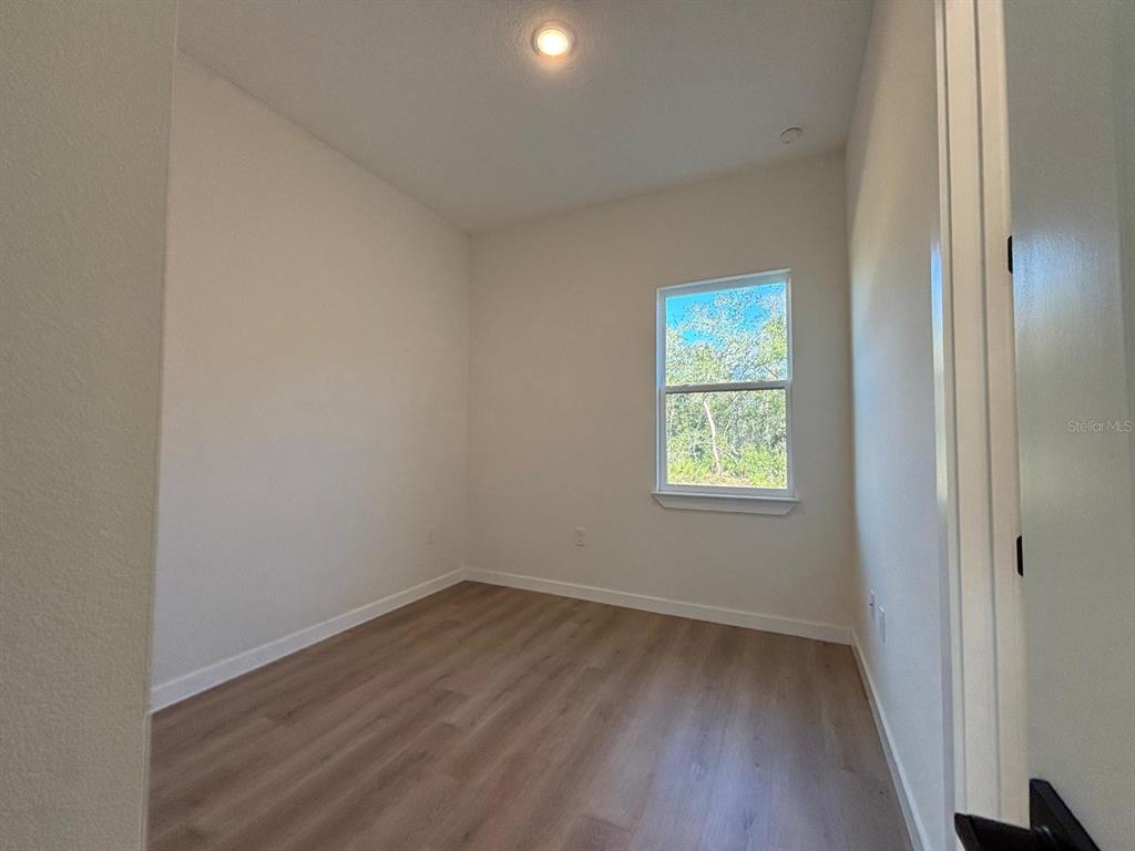 15215 Southwest 43rd Court Ocala, FL 34473 - Photo 16 of 29 an empty room with wooden floor and windows