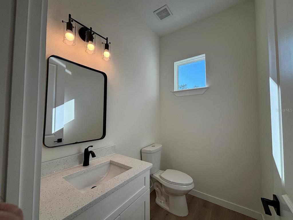 15215 Southwest 43rd Court Ocala, FL 34473 - Photo 20 of 29 a bathroom with a toilet sink and mirror