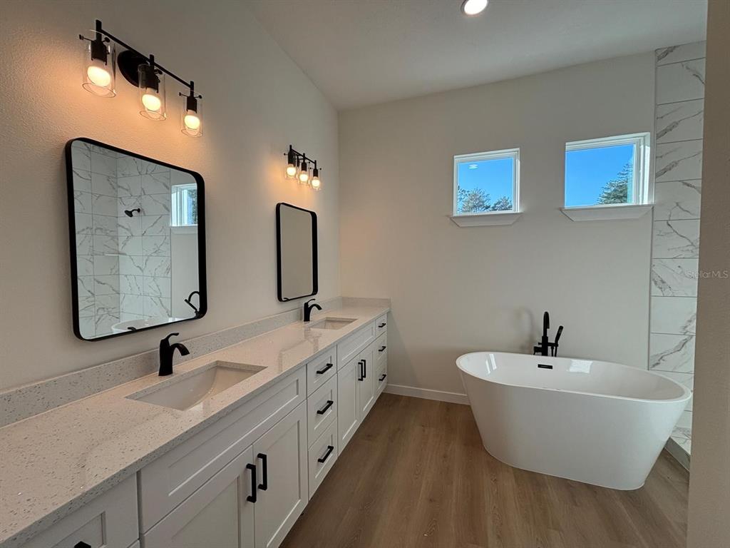15215 Southwest 43rd Court Ocala, FL 34473 - Photo 22 of 29 a bathroom with a double vanity sink and a mirror