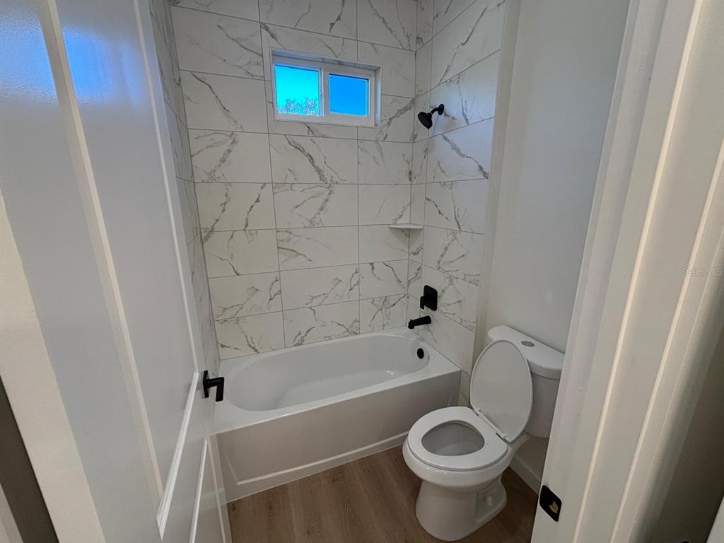 15215 Southwest 43rd Court Ocala, FL 34473 - Photo 24 of 29 a bathroom with a toilet and a tub