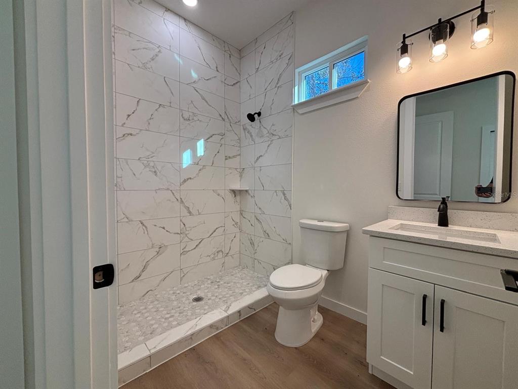 15215 Southwest 43rd Court Ocala, FL 34473 - Photo 25 of 29 a bathroom with a sink a toilet and shower