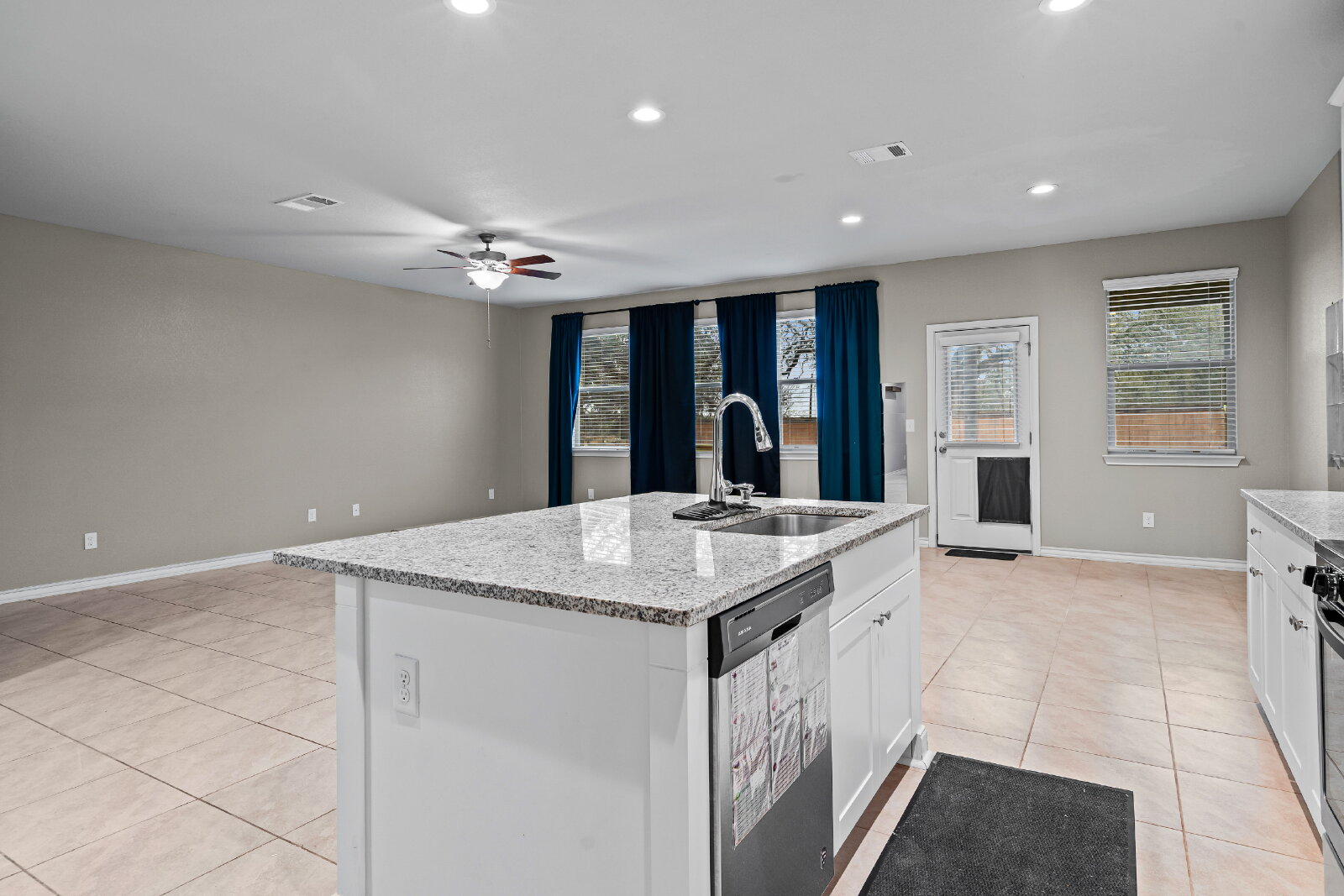 204 Tulum Terrace Leander, TX 78641 - Photo 11 of 22 Kitchen featuring light stone counters, light tile patterned floors, dishwasher, ceiling fan, and recessed lighting