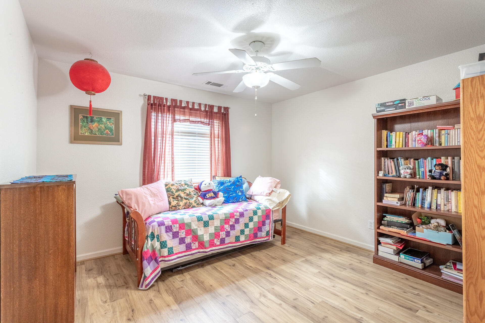 1343 Britt Lane Red Bluff, CA 96080 - Photo 12 of 17 a bedroom with a bed and a book shelf