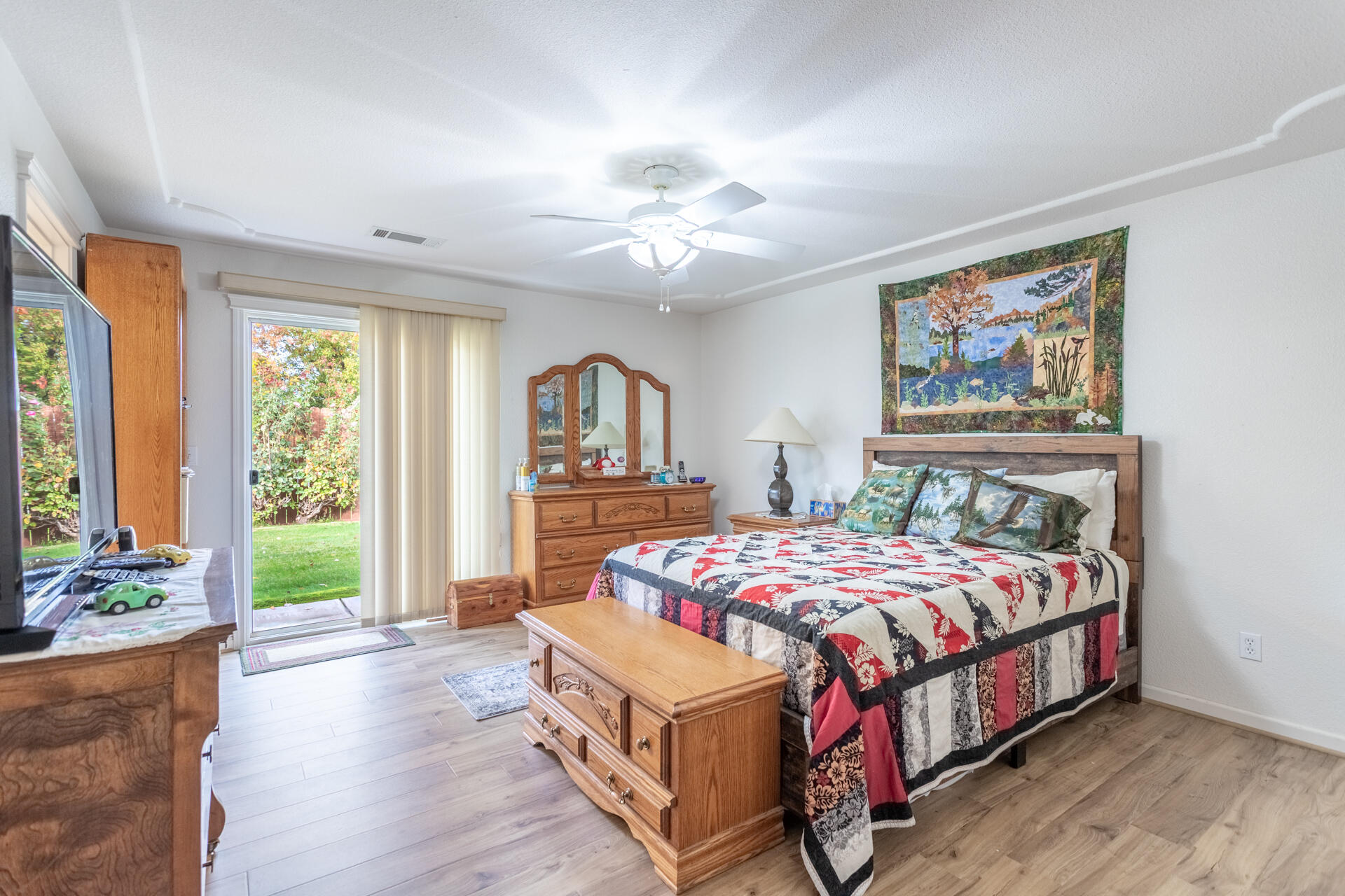 1343 Britt Lane Red Bluff, CA 96080 - Photo 8 of 17 a bedroom with a large bed and a chandelier