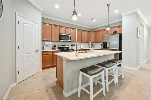 a kitchen with a sink stainless steel appliances and white cabinets