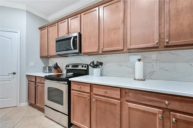 a kitchen with stainless steel appliances granite countertop white cabinets a sink and a dishwasher with wooden floor