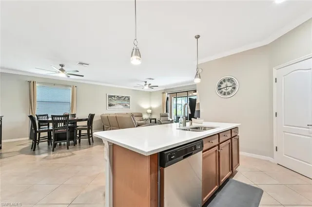 a large kitchen with kitchen island a sink counter and chairs