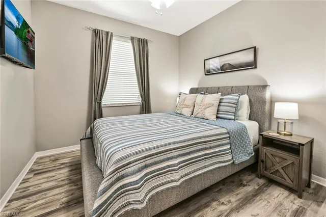 a bedroom with a bed and a tv