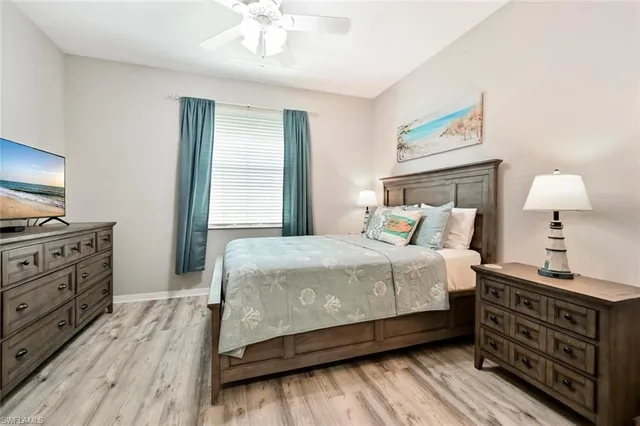 a bedroom with a bed and a tv on the dresser