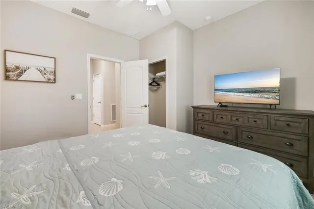 a large bedroom with a bed and a television