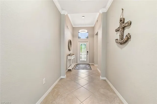 a view of a hallway with wooden floor and a bathroom