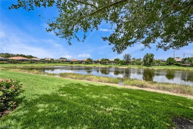 a view of a lake with houses in the back