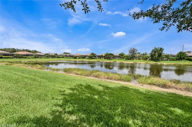 a view of a lake with houses in the back