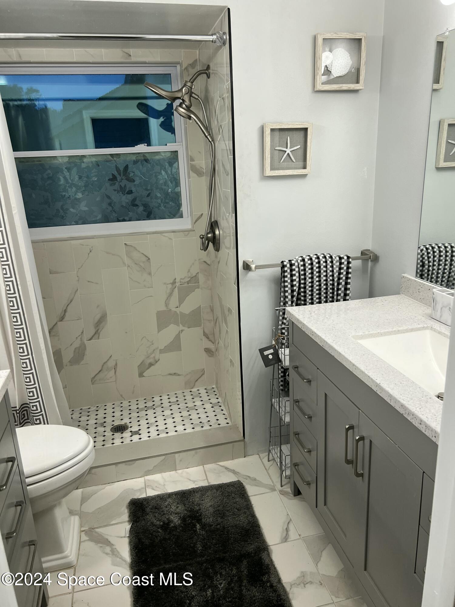 1668 Clover Circle Melbourne, FL 32935 - Photo 6 of 16 a bathroom with a toilet and a shower