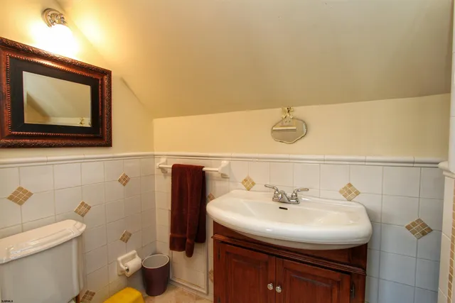 a bathroom with a sink a toilet and mirror