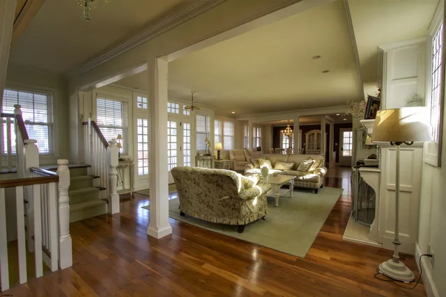 a living room with lots of furniture and a glass door