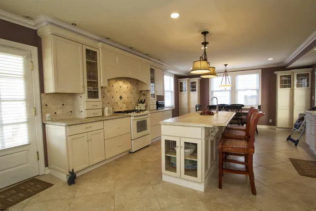 a kitchen with a white cabinets stove and refrigerator