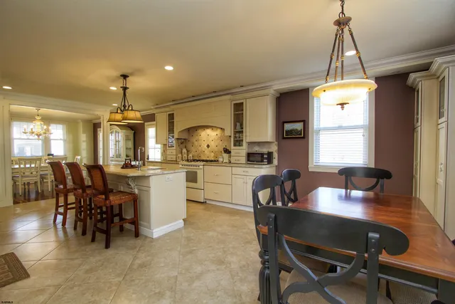 a dining room with furniture a chandelier and window