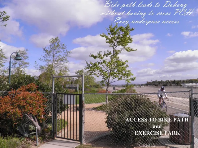 a view of a pathway with a wrought fence