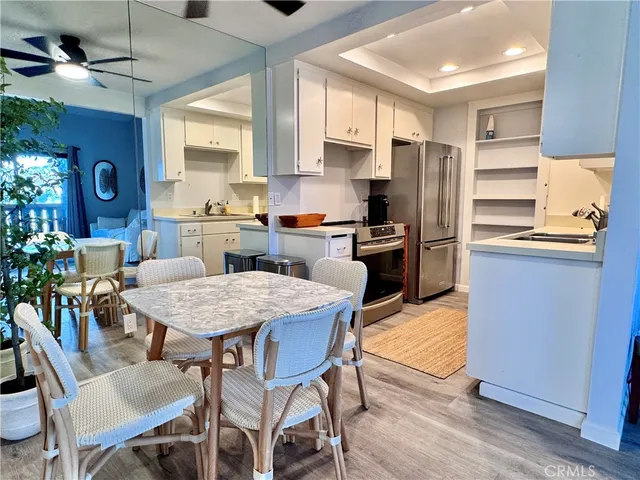 a kitchen with granite countertop a sink dishwasher stove and cabinets